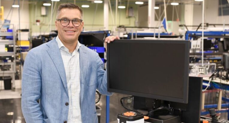Jeremy Maniak with Product Innovation of the Year winning device, The Novasight Hybrid System.