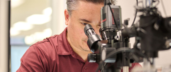 Man looking through a microscope